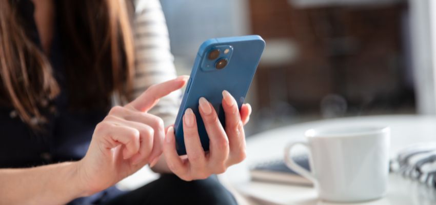 The woman uses his iPhone to sign documents.