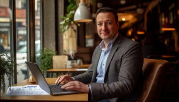 A businessman in Germany uses an e-signature tool to sign digital contracts.
