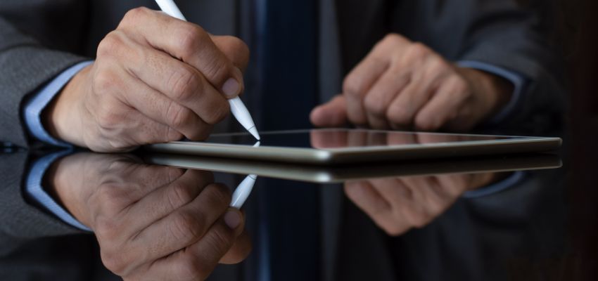The entrepreneur signs a digital contract.